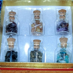 6 sample glass bottles of gem stones