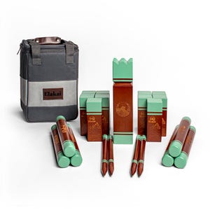 May include: A set of wooden lawn game pieces in brown and green with a carrying bag. The game includes 10 wooden blocks, 4 wooden stakes, and a gray canvas bag with the word "Elakai" printed on it.