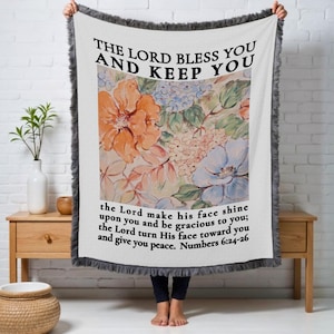 May include: White throw blanket with a floral design and the text "THE LORD BLESS YOU AND KEEP YOU" and a Bible verse from Numbers 6:24-26.