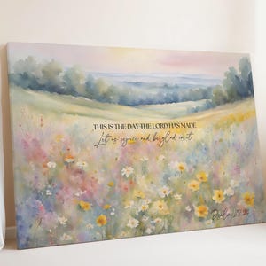 May include: A canvas print featuring a watercolor landscape of a field of wildflowers in shades of yellow, pink, and purple. The artwork includes the text "THIS IS THE DAY THE LORD HAS MADE, Let us rejoice and be glad in it" and "Psalm 118:24".