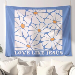 May include: A blue tapestry with a white daisy pattern and the text "LOVE LIKE JESUS" in white letters.
