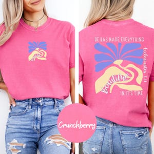 May include: Pink t-shirt with a floral design and the text "He has made everything beautiful in it's time Ecclesiastes 3:11" on the back.