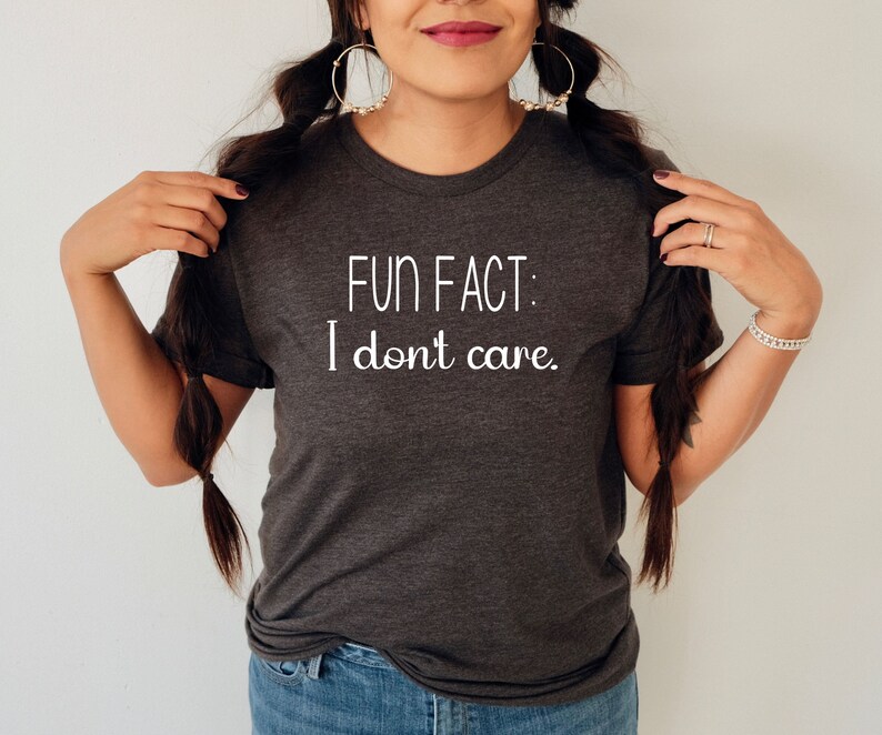 May include: A dark gray t-shirt with the text "FUN FACT: I don't care." printed in white.