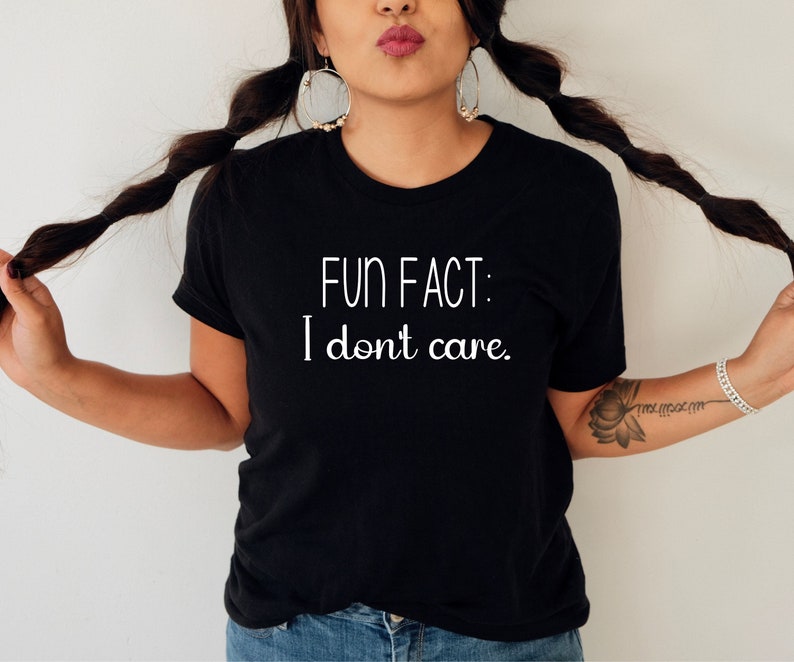 May include: Black t-shirt with white text that reads "FUN FACT: I don't care."