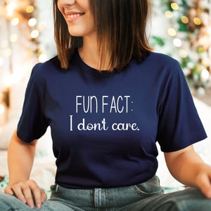 May include: A navy blue t-shirt with white text that reads "FUN FACT: I don't care."