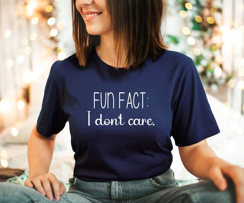 May include: A navy blue t-shirt with white text that reads "FUN FACT: I don't care."