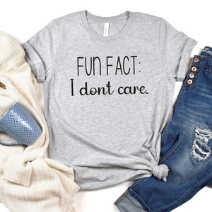 May include: A gray t-shirt with the text "FUN FACT: I don't care." printed in black.