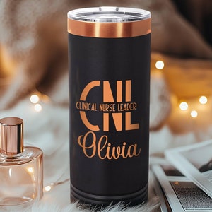 May include: A black and copper travel mug with the text "CNL Clinical Nurse Leader Olivia" in gold lettering.
