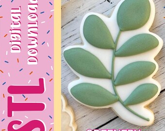 Può includere: Un biscotto a forma di foglia decorato con glassa bianca e foglie verde salvia. L'immagine presenta una barra laterale rosa con zuccherini colorati e il testo digital download, STL e GREENERY in grassetto bianco e rosa.