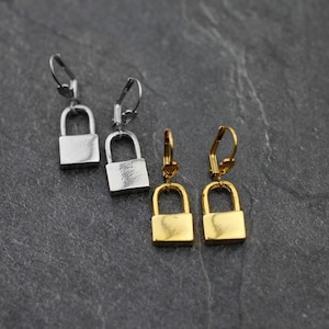 May include: A pair of silver padlock earrings and a pair of gold padlock earrings. The earrings are dangle style with a hook fastening.