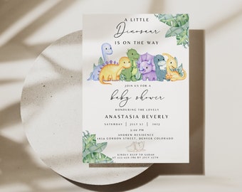 May include: A baby shower invitation with a dinosaur theme. The invitation features a group of colorful dinosaurs with green leaves and the text "A Little Dinosear is on the way."  The invitation also includes the text "Join us for a baby shower honoring the lovely Anastasia Beverly, Saturday, July 17, 2023, 3:00 PM, Andrew Residence, 1854 Gordon Street, Denver Colorado. Kindly RSVP to Sarah at 512-420-1829 by July 15th."