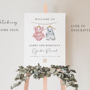 May include: A gender reveal welcome sign with a watercolor illustration of a pink baby outfit and a blue baby outfit hanging on a clothesline. The sign reads "Welcome to James and Romana's Gender Reveal, Saturday July 17, 2024 at 1 PM".
