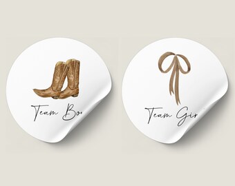 May include: Two round stickers with a white background. One sticker has a pair of brown cowboy boots and the text "Team Boy". The other sticker has a brown ribbon bow and the text "Team Girl".