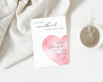 May include: A pink watercolour heart with the text "A little sweetheart is on the way!" Join us for a baby shower honouring Izabelle Willens on 17 June 2023 at 3:00 PM. 1234 Gordon Street, Denver, Colorado. RSVP to Sarah at 323-456-7890.