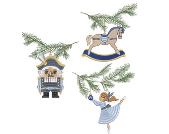May include: Three Christmas ornaments hanging from pine branches. The ornaments are a nutcracker, a rocking horse, and a ballerina. The nutcracker is wearing a blue and gold uniform. The rocking horse is brown and white with blue accents. The ballerina is wearing a blue dress and has brown hair.