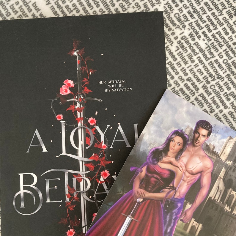 May include: A black book cover with a silver sword and red flowers. The title of the book is "A Loyal Betrayal" and the subtitle is "Her Betrayal Will Be His Salvation".