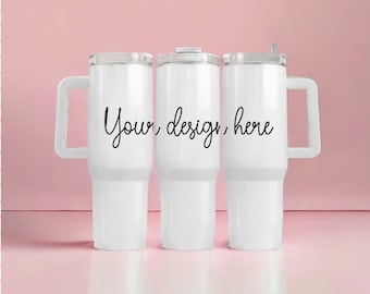 May include: Three white insulated tumblers with handles and clear lids. The tumblers have the text "Your design here" in a cursive font. The background is a solid pink colour.