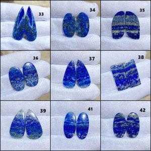 May include: Ten pairs of blue and white lapis lazuli cabochons, each pair numbered 33 through 42. The cabochons are oval, teardrop, and rectangular shapes.