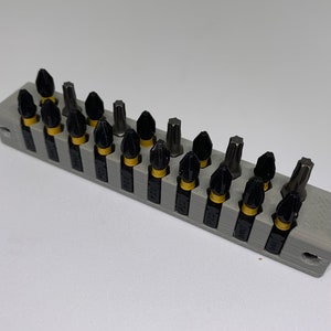 Wall mounted screwdriver bit holder. This holds 20 bits.