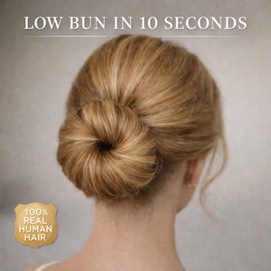 May include: A low bun hairstyle made of blonde hair, with the text "LOW BUN IN 10 SECONDS" at the top. The image also includes a gold emblem that reads "100% REAL HUMAN HAIR".