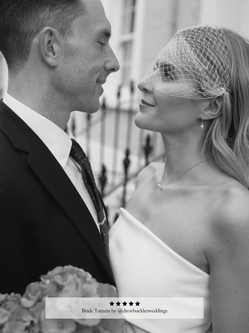 May include: Black and white image of a couple looking at each other. The woman wears a white dress and a veil. The man is in a suit. The text "Bride Tamzin by @drewbucklerweddings" is at the bottom.