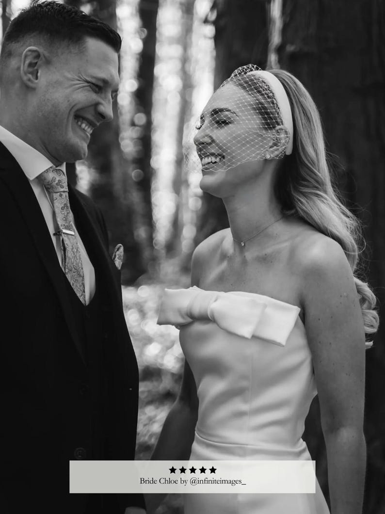 May include: Black and white photo of a smiling couple. The woman wears a strapless white dress with a bow. She has a veil and headband. The man wears a suit and tie. Text reads "Bride Chloe by @infiniteimages_."