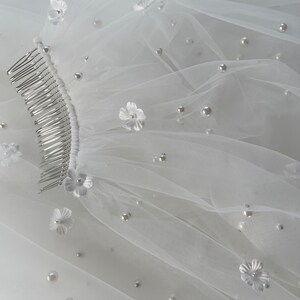 Pearl Veil with Flowers a 3d ivory pearl veil style Every bridal pearl floral veil is handmade in my studio using premium ivory scattered pearls tulle hand stitched with individual flowers creating a veil with floral appliqué and pearls that is totally unique each time A petals and pearl veil is a style suit many different bridal looks, as the colour is the perfect shade of ivory quality of this pearls scattered veil is unlike any other a true heirloom piece that can be passed on for generations