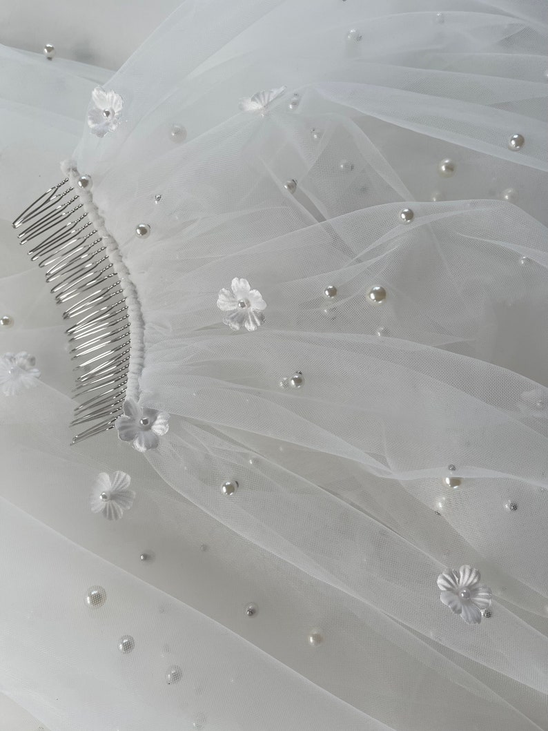 Pearl Veil with Flowers a 3d ivory pearl veil style Every bridal pearl floral veil is handmade in my studio using premium ivory scattered pearls tulle hand stitched with individual flowers creating a veil with floral appliqué and pearls that is totally unique each time A petals and pearl veil is a style suit many different bridal looks, as the colour is the perfect shade of ivory quality of this pearls scattered veil is unlike any other a true heirloom piece that can be passed on for generations
