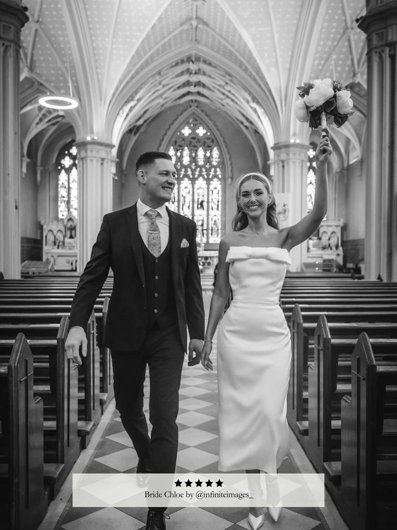 May include: A grayscale image of a wedding couple walking down the aisle of a church. The bride wears a white, strapless dress and holds a bouquet. The groom wears a dark suit. The image includes the text "Bride Chloe by @infiniteimages_".