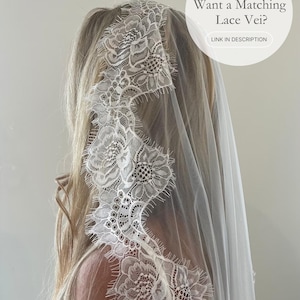 May include: A white lace veil with floral detailing. The veil is draped over the head and shoulders. The text on the image says, "Want a Matching Lace Veil?" and "LINK IN DESCRIPTION".