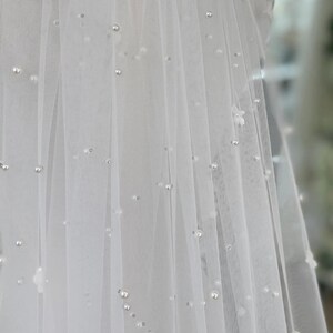 Pearl Veil with Flowers a 3d ivory pearl veil style Every bridal pearl floral veil is handmade in my studio using premium ivory scattered pearls tulle hand stitched with individual flowers creating a veil with floral appliqué and pearls that is totally unique each time A petals and pearl veil is a style suit many different bridal looks, as the colour is the perfect shade of ivory quality of this pearls scattered veil is unlike any other a true heirloom piece that can be passed on for generations