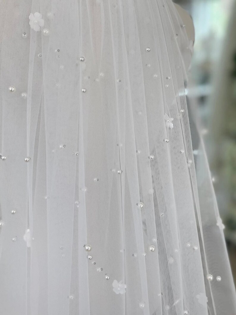 Pearl Veil with Flowers a 3d ivory pearl veil style Every bridal pearl floral veil is handmade in my studio using premium ivory scattered pearls tulle hand stitched with individual flowers creating a veil with floral appliqué and pearls that is totally unique each time A petals and pearl veil is a style suit many different bridal looks, as the colour is the perfect shade of ivory quality of this pearls scattered veil is unlike any other a true heirloom piece that can be passed on for generations