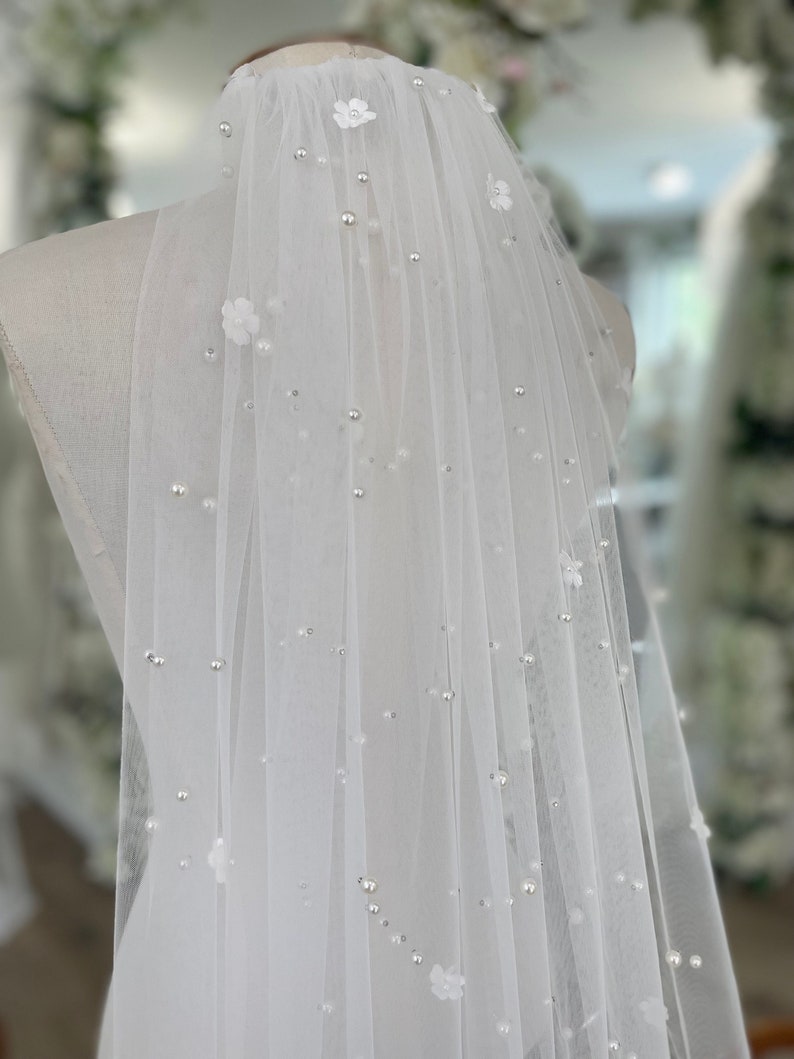 Pearl Veil with Flowers a 3d ivory pearl veil style Every bridal pearl floral veil is handmade in my studio using premium ivory scattered pearls tulle hand stitched with individual flowers creating a veil with floral appliqué and pearls that is totally unique each time A petals and pearl veil is a style suit many different bridal looks, as the colour is the perfect shade of ivory quality of this pearls scattered veil is unlike any other a true heirloom piece that can be passed on for generations