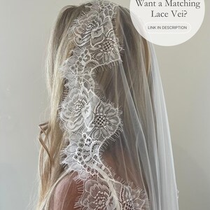 May include: A white lace veil with floral detailing. The veil is draped over the head and shoulders. The text on the image says, "Want a Matching Lace Veil?" and "LINK IN DESCRIPTION".