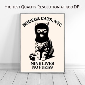 May include: A black and white illustration of a cat wearing a black ski mask. The cat is sitting with its paws crossed. The text "Bodega Cats, NYC" is above the cat and the text "Nine Lives No Fucks" is below the cat.