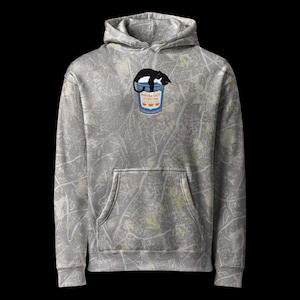 Puede incluir: Una sudadera con capucha gris con un patrón de camuflaje. La parte delantera presenta un gráfico de un gato negro durmiendo sobre un cubo de palomitas de maíz azul con el texto "Popcorn Cats" y "The Movie". La sudadera tiene un bolsillo delantero y una capucha.