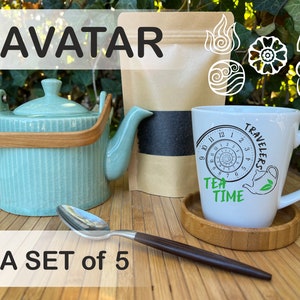 May include: A teal teapot with a wooden handle, a white mug with a black and green design that says "Travelers Tea Time", a wooden coaster, and a silver spoon. The mug has a clock face with a spiral design. The background is a green leafy plant.
