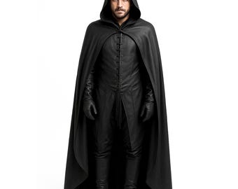 May include: A black hooded cloak and matching outfit. The cloak has a long, flowing design with a hood. The outfit includes a long-sleeved shirt with a lace-up front, pants, gloves, and boots. The outfit is made of a dark, possibly leather-like material.
