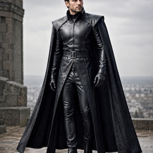 May include: A black leather ensemble consisting of a long-sleeved jacket with a high collar, a matching floor-length cape with structured shoulders, slim-fit trousers, a belt with a rectangular buckle, and black leather gloves and boots.
