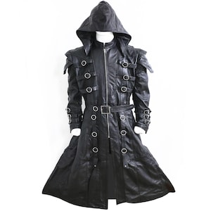 May include: Black leather hooded coat with a zip-up front, shoulder accents, and multiple silver-tone metal ring details. The coat features a belt at the waist and a long, flowing skirt. The garment is designed with a gothic or steampunk aesthetic.