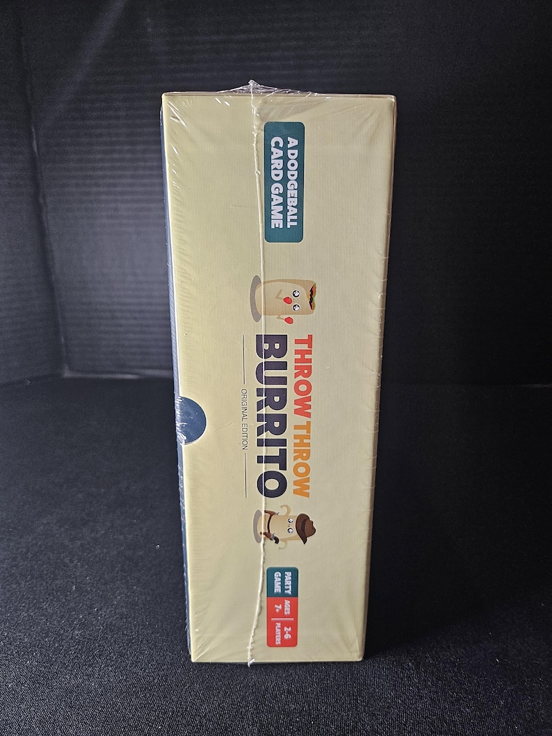 May include: A yellow box with a cartoon burrito on the front. The box says "Throw Throw Burrito" and "A Dodgeball Card Game". The box is shrink-wrapped.