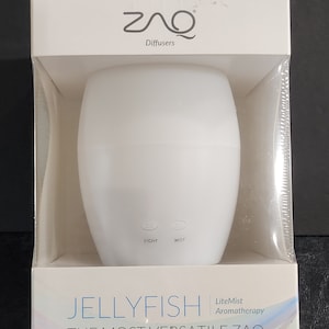May include: White ceramic diffuser shaped like a jellyfish with a light and mist button. The box reads "Jellyfish LiteMist Aromatherapy The Most Versatile Zaq"