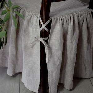 The full-length skirt chair cover made of 100 % prewashed organic linen . Custom chair slipcover.