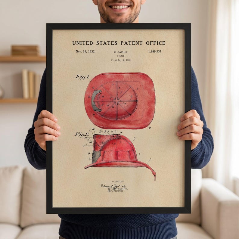 The image is a framed patent drawing depicting a red fire helmet with a circular design on the side.
