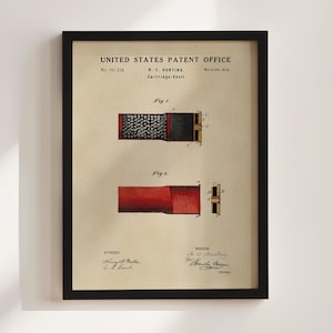 May include: Framed patent print from the United States Patent Office, dated March 30, 1875, featuring a detailed illustration of a cartridge shell. The print includes technical drawings, the inventor's name, and witness signatures, all set against a beige background.