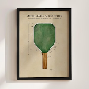 May include: A framed print of a patent illustration for a ping pong paddle. The paddle has a green playing surface and a wooden handle. The text "UNITED STATES PATENT OFFICE" is at the top.