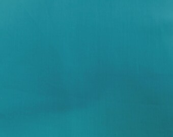 May include: Solid teal background. The image is a close-up of a smooth, solid teal surface. The color is a vibrant, medium shade of teal, with subtle variations in tone across the surface. The texture appears smooth and uniform.