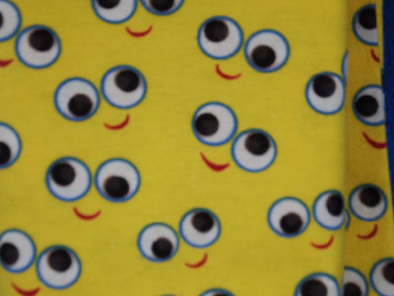 Large Googly Eyes Smiley Faces on a Yellow Background Flannel Fabric