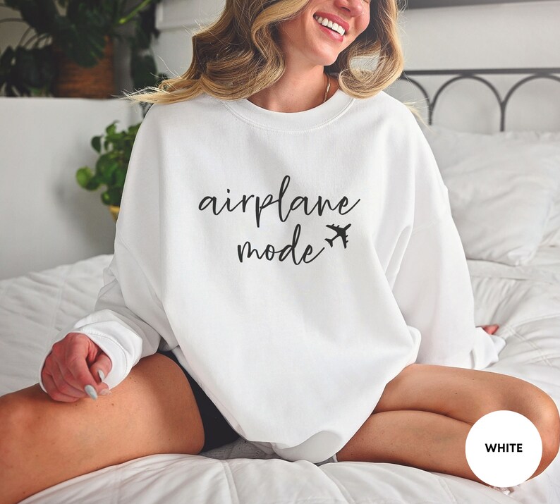 May include: White sweatshirt with the text "airplane mode" and a small airplane icon in black.