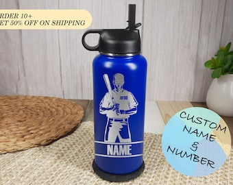 May include: Blue stainless steel water bottle with a black lid and a straw. The bottle has a baseball player graphic with the text "#00" and "NAME" engraved on it.